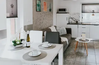 a living room with a couch and a table at APARTAMENTY LAS Zator in Zator