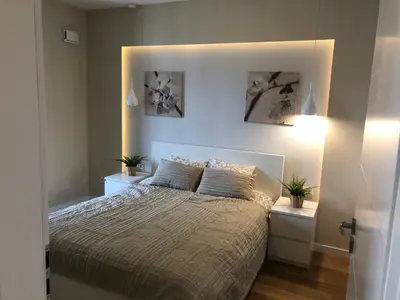 a bedroom with a large bed with two night stands at Browar Lubicz by Atrium Apartments in Kraków