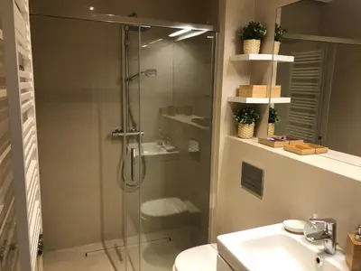 a bathroom with a shower and a toilet and a sink at Browar Lubicz by Atrium Apartments in Kraków