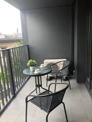 a balcony with a table and chairs on it at Browar Lubicz by Atrium Apartments in Kraków