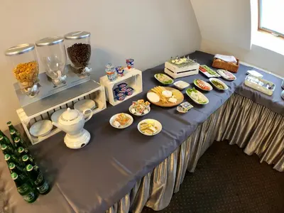 a table with plates of food on it at Hotel Nad Stawem in Skalbmierz