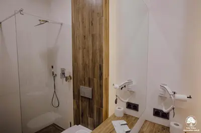 a bathroom with a shower and a toilet and a sink at Hotel Nad Stawem in Skalbmierz