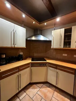 a kitchen with white cabinets and a stove top oven at FLORIANSKA Penthouse DeLux in Kraków