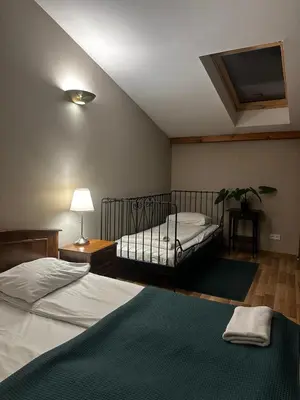 a bedroom with two beds and a flat screen tv at FLORIANSKA Penthouse DeLux in Kraków