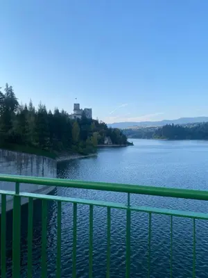 a view of a river with a green railing at Apartament w górach Gorce in Nowy Targ