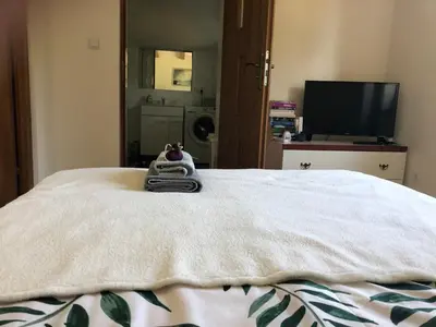 a bed with a towel and a stuffed animal on it at Czytelnia w Sadzie in Krzykawka