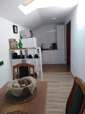 a kitchen with a table with a basket of food on it at Czytelnia w Sadzie in Krzykawka