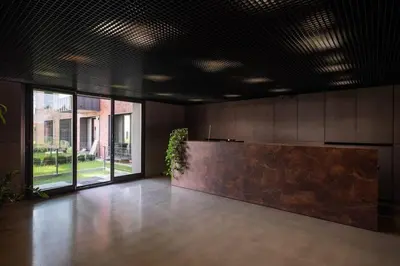 a lobby with a reception desk and a large window at Stylish Apartment Luminis in Krakow's Kazimierz in Kraków