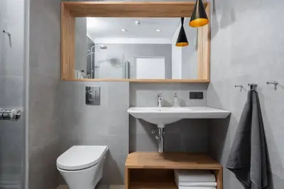 a bathroom with a sink and a toilet and a mirror at Stylish Apartment Luminis in Krakow's Kazimierz in Kraków