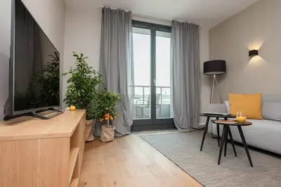 a living room with a couch and a tv at Stylish Apartment Luminis in Krakow's Kazimierz in Kraków