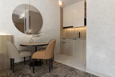 a dining room with a table and chairs and a mirror at ZatorHome apartamenty - blisko Energylandii i Zatorlandu in Zator