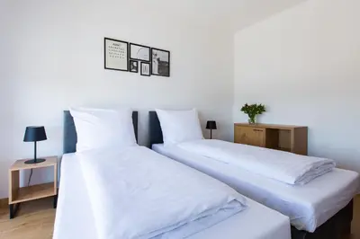 two beds sitting next to each other in a room at ZatorHome apartamenty - blisko Energylandii i Zatorlandu in Zator