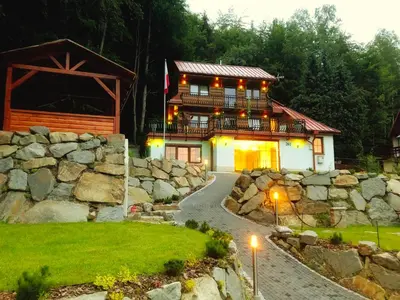 a house with a stone wall and a stone path at LaVerde - Blisko Przyrody Daleko od Tłumu in Skomielna Czarna