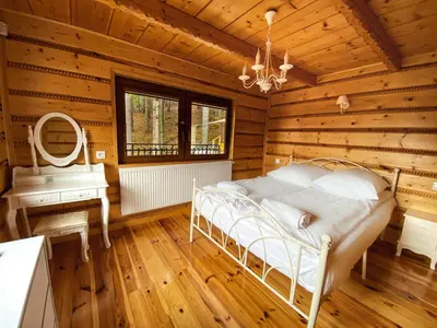 a bedroom with a bed in a wooden room at LaVerde - Blisko Przyrody Daleko od Tłumu in Skomielna Czarna