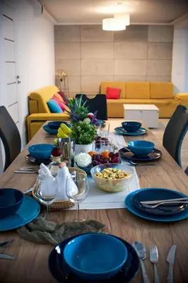 a wooden table with blue plates and bowls of food at LaVerde - Blisko Przyrody Daleko od Tłumu in Skomielna Czarna
