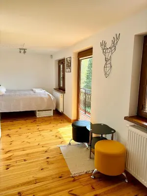 a bedroom with a bed and a table and chairs at LaVerde - Blisko Przyrody Daleko od Tłumu in Skomielna Czarna