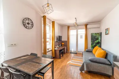 a living room with a table and a couch at Apartament Chmielna Loft in Kraków