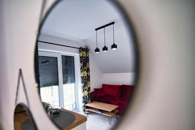 a view of a living room with a red couch at Blue Sky - Apartamenty Premium Zator in Zator