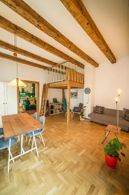 a large living room with a wooden table and chairs at PRZEPIĘKNY APARTAMENT w sercu Starego Miasta in Kraków