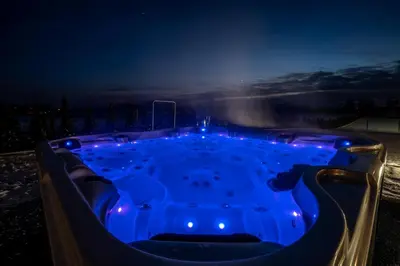 a jacuzzi tub with blue lighting at night at Stacja Galicja - nocleg w pociągu blisko Energylandia in Zator