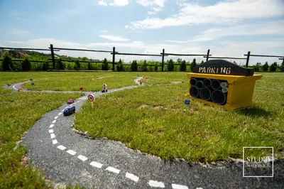a toy road with a toy car in a field at Stacja Galicja - nocleg w pociągu blisko Energylandia in Zator