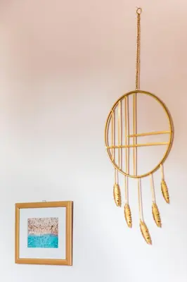 a chandelier hanging from a wall next to a picture at WSPANIAŁY, Stylowy Apartament w Sercu Starego Miasta in Kraków