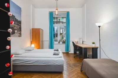 a small room with two beds and a desk at Krasińskiego Apartments - LOW STANDARD - Riverside & Old Town - by Upstairs in Kraków