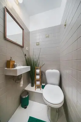 a bathroom with a white toilet and a sink at Krasińskiego Apartments - LOW STANDARD - Riverside & Old Town - by Upstairs in Kraków