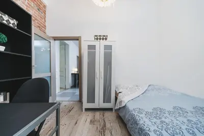 a bedroom with a bed and a desk and a door at Krasińskiego Apartments - LOW STANDARD - Riverside & Old Town - by Upstairs in Kraków