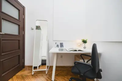 a room with a desk and a chair and a mirror at Krasińskiego Apartments - LOW STANDARD - Riverside & Old Town - by Upstairs in Kraków