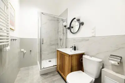 a bathroom with a shower and a toilet and a sink at Native Apartments Żuławskiego 8 in Kraków