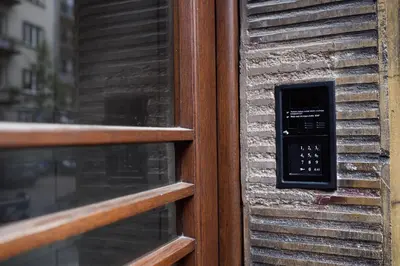 a door with a phone on the side of a building at Native Apartments Żuławskiego 8 in Kraków