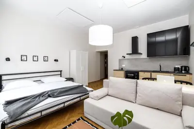 a bedroom with a bed and a couch at Native Apartments Żuławskiego 8 in Kraków