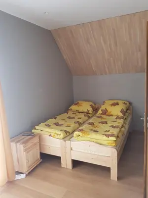 a room with two beds in a room at Na Zakręcie in Ochotnica Górna