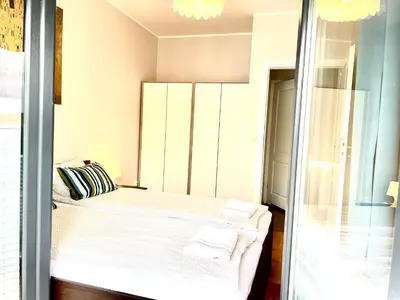 a small bedroom with a bed and a glass door at Froja in Zator