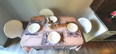 a pink table with white plates on top of it at Apartament Orchidea in Kraków