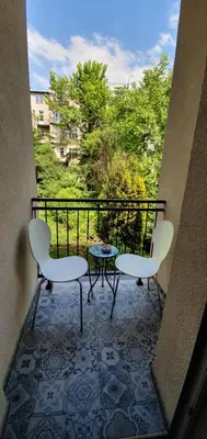two chairs and a table on a balcony at Apartament Orchidea in Kraków