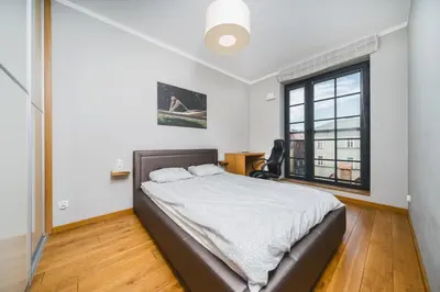 a bedroom with a large bed and a window at Glam Brewery Suite - Deluxe Apartment with Parking - by Upstairs in Kraków
