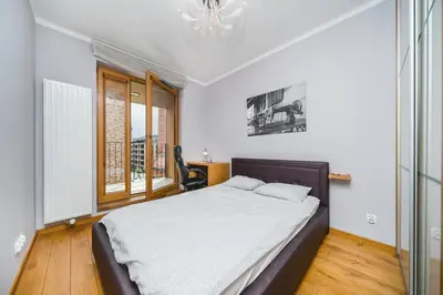 a bedroom with a large bed and a window at Glam Brewery Suite - Deluxe Apartment with Parking - by Upstairs in Kraków