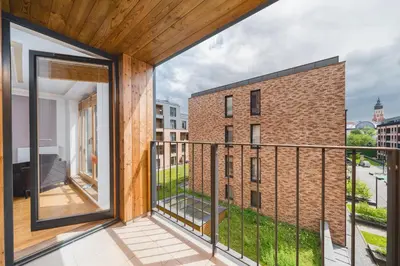 a balcony with a view of a brick building at Glam Brewery Suite - Deluxe Apartment with Parking - by Upstairs in Kraków
