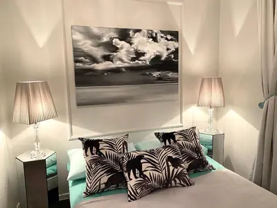 a bedroom with a bed with zebra pillows and two lamps at DREAM Boutique Apartment 42m2 in the heart of Cracow Old Town in Kraków