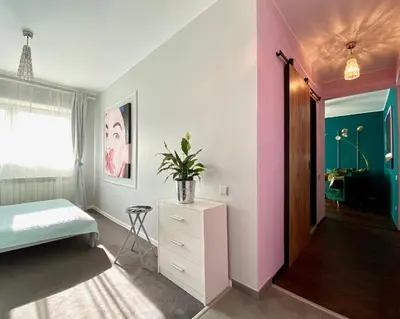 a bedroom with a bed and a plant on a dresser at DREAM Boutique Apartment 42m2 in the heart of Cracow Old Town in Kraków