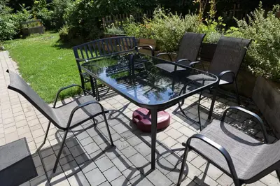 a glass table and chairs on a patio at Agroturystyka u Babci in Czchów