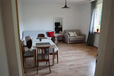 a living room with a table and chairs and a couch at Agroturystyka u Babci in Czchów
