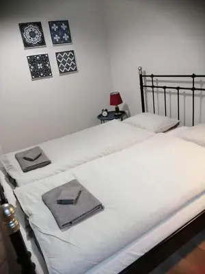 two beds in a room with pictures on the wall at Apartament Galicja Plus in Chrzanów