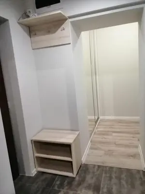 a room with a shelf and a tv on a wall at Apartament Galicja Plus in Chrzanów