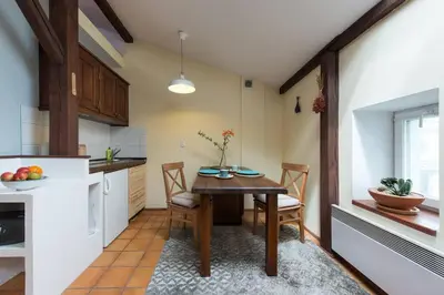 a kitchen with a table and chairs in a room at Bright loft in amazing location in Kraków