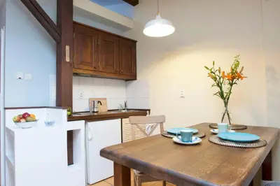 a kitchen with a wooden table with blue dishes on it at Bright loft in amazing location in Kraków