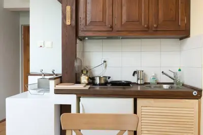 a kitchen with a sink and a counter top at Bright loft in amazing location in Kraków