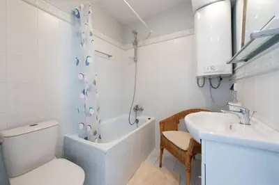 a bathroom with a toilet and a tub and a sink at Bright loft in amazing location in Kraków